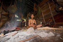 Young Korowai woman and her mother sitting in their treehouse, West Papua