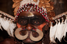 Asmat man with traditional headdress during a funeral ceremony, West Papua